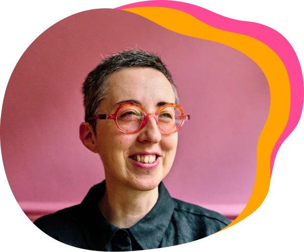 Hannah smiling in the coaching for difference brand shape with orange and pink waves.
